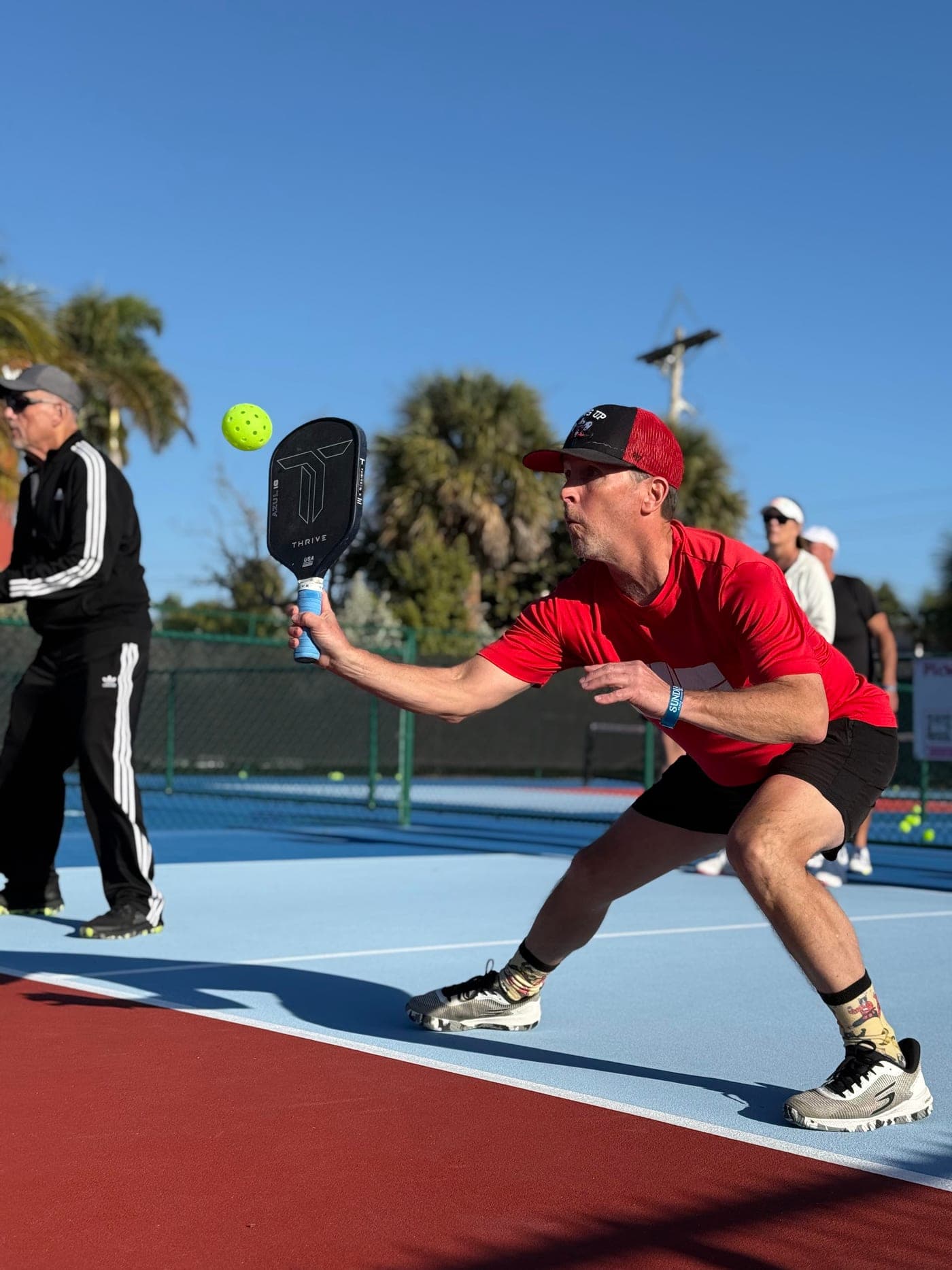 David S. stretching low for a volley at the kitchen line