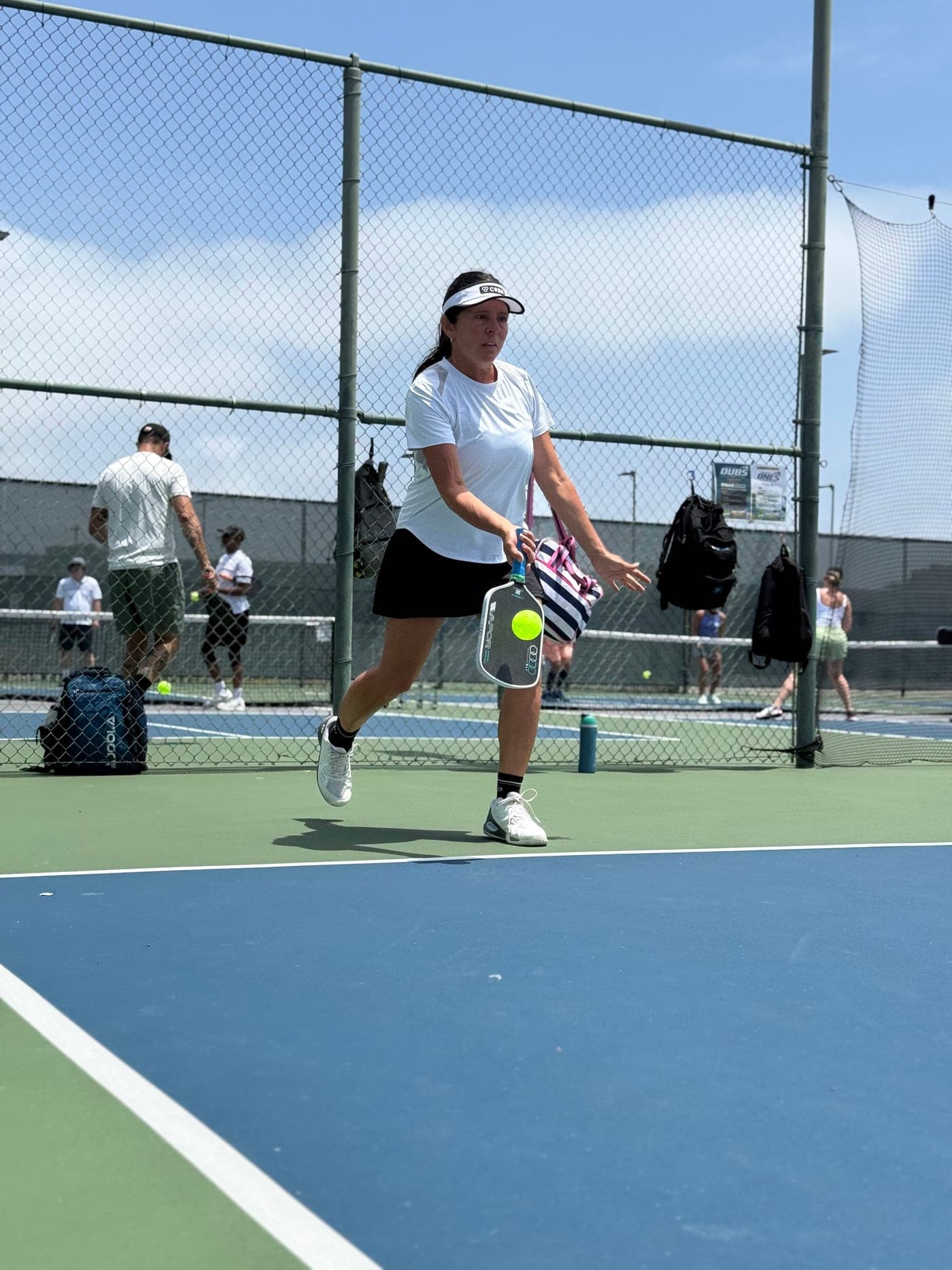 Amy Z. returning serve on a sunny court