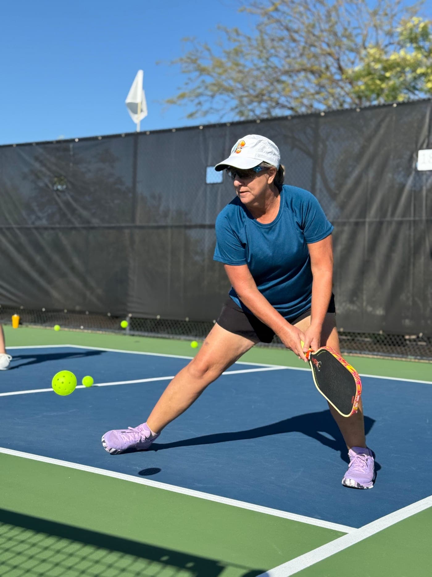 Dana A. lunging low for a dink at the net